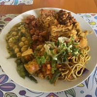 A platter of Chickpeas, noodles, salad, bbq vegan nuggets, potato, and string beans .  at The Vegan Spot in Charlestown