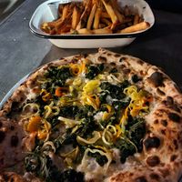Pizza and a side of fries with vegan aioli at Strangebird in Rochester