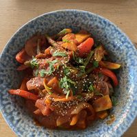 Momos with sautéed veggies in a spicy sauce  at MoMo Café in Friedrichsdorf