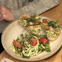 Huge plate of avo toast with kimchi and tempeh   at Booch Cafe in Riga