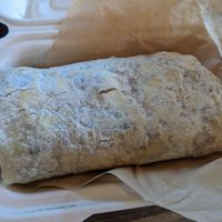 Big burrito with egg substitute, vegan sausage, vegan cheese, mushrooms, potatoes, avocado, and arugula. Delicious. at Roots Gastrohub in Grand Junction