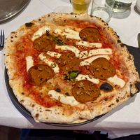 Fuoco Dolce - San Marzano Tomato, Casadei vegan mozzarella, vegan spicy salame, hot maple syrup, crispy onions, basil, & Extra-Virgin Olive Oil at Corte Campana in Stratford-upon-avon