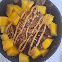 Oatmeal with mango and dates at Organic Coco Bowls  in Muscat
