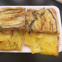 Slice of spicy aubergine pizza and slice of potato with rosemary pizza at Alice Pizza Tivoli in Tivoli