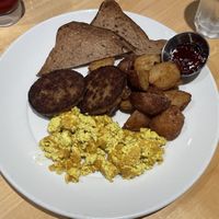 On the menu as “Impossible Eggs”, Pan seared Impossible sausage, Indian spiced tofu scramble, served with crispy potato and gluten free toast.   at Abode in Vancouver