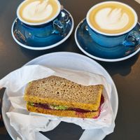 Oat milk Cappuccinos and Tempeh Sandwich at Coffeedesk Kawiarnia - Tamka in Warsaw