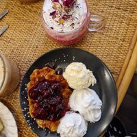 Berry waffles and pink rose latte. at Canterbury Tails Cat Cafe in Canterbury