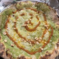 Pizza con mozzarella vegana, crema di friarielli, crema di pomodorini secchi e granella di nocciole.  at Giovanni Santarpia in Florence