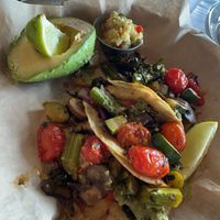 Vegan tacos! Broccolini, mushroom, tomato, and cabbage in corn tortillas with a side of avocado and pineapple pico. 10/10.  at The Boathouse in Lake Buena Vista