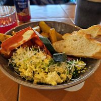 Breakfast bowl with tofu scramble, "bacon," and potato wedges at Nihe in Tallinn
