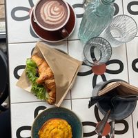 Raw cacao, „salmon“ croissant and cheese roll. at Nihe in Tallinn