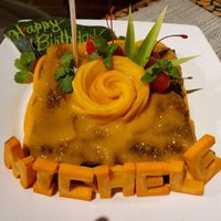 "Michele" cake made of all healthy ingredients including only organic ingredients & fruit sugars (bananas & raisins), whole oats and carrots. Topped with mango and a mango rose! at Atlantis Restaurant in Puerto Galera