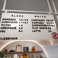 On pink sticker " no extra charge for Oatly" at Café Lieben Wir in Vienna