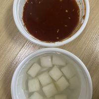 The seasoned spicy sauce (which wasn’t actually spicy) and complementary radish kimchi(?)  at Vampire's Chicken in Seoul