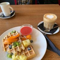 waffles with fruit and oat milk latte  at MiiT in Riga