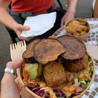 Regular Falafel in a box with aubergine on top. In background is falafel & hummus pot with tomato coriander and lime sauce    at Eat a Pitta - Clifton Village in Bristol