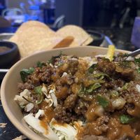 Impossible Asada Bowl, chips and salsa in the background  at Mas Taco Bar in Sacramento