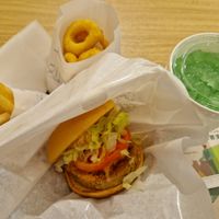 Veggie burger, fries, onion rings, melon soda at Mos Burger - Chiyoda in Tokyo
