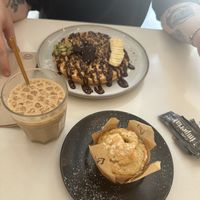 Lemon muffin and waffles with chocolate sauce and an oat iced latte   at Balino Yoga Café  in Sevilla