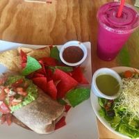 Black Bean and Brown Rice Burrito, Pitaya Smoothie. 10/10 would recommend that smoothie. Burrito needs some peppers and onions inside. Was a good size/very filling though! at Swami's Cafe in Oceanside