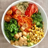 Buddha bowl - tofu, kale, roasted curried chickpeas, carrots, quinoa, tomatoes and peppers with a light peanut sauce at Quinoa in Las Condes