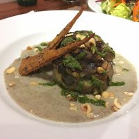 On a topinambur cream, a dish with aubergine and artichokes at Quinoa in Las Condes