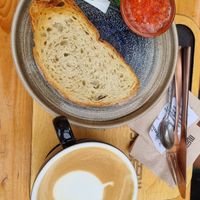 Bread with tomato and oatmilk latte at Madness Coffee Benidorm in Benidorm