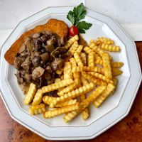 Schnitzel with mushroom cream sauce and fries €16 + €5 at Die Sonnenuhr in Zeltingen