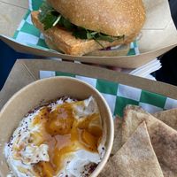 tofu sammy and labneh and pita on the bottom   at Mishmish Souq in Oakland