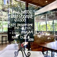 Raw vegan nut bites listed on the chalkboard on this small refrigerator   at Cafe Social in Puntarenas