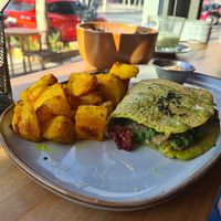 Funghi, sundried tomato, Vegan mozza, peas, and bravas in a spinach/chickpea omelette at Morgentau. in Barcelona
