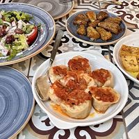 Horiatiki salad, cabbage dolmades, zucchini flower and baked potatoes   at Hamam Cafe in Rhodes