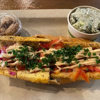Spicy tofu sandwich with sides of not-chicken nuggets (upper left) and cucumber-dill potato salad (upper right) at Sia's in Pittsburgh