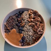 Oatmeal bowl with cacao, chia seeds, hemp seeds, blueberries, und Walnüsse    at Lucy's The Deli in Berlin