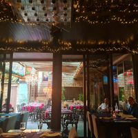 The restaurant with outdoor sitting and open kitchen. at Praceta in Santa Maria Da Feira