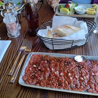 Ezme salad, mix of tomatoes, onions, pomegranate and parsley   at Dinnio in Hertford