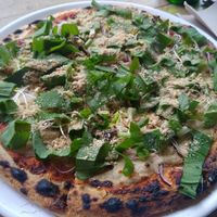 Weekly pizza with broccoli, wild garlic, and cashew parmigiano at NOAH in Mainz