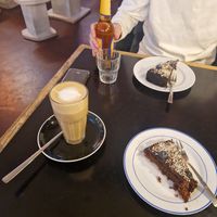 Oat latte and a vegan cinnamon cake at The Source in Berlin