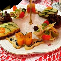 Savory vegan bites including sweet potato butterflies, mushrooms topped with Queen Anne’s lace, cucumber and roasted red pepper hummus sandwiches, and farfalle pasta with olives. at Queen of Hearts in Henderson