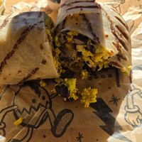 Happy Cow Burrito on a gluten-free wrap. Added black beans. at Rise Up Coffee in Cambridge