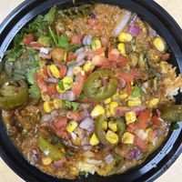 Rice bowl with a mix of chana, spinach and lentils, and various toppings   at The Twist Indian Grill in Dayton