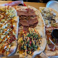 Vegan pizza flight! (Bee sting in bottom right, vegan with honey on the side) at The Mitten Brewing Co in Grand Rapids