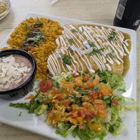 Three enchilada platter with rice, beans, and salad at Sol Of Mexico in Worcester