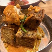 makhani mille feuille: crunchy layered potato cubes, cashew makhani sauce  at Mallow - Canary Wharf in East London
