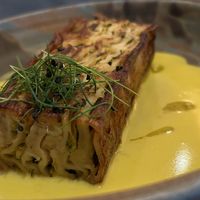 zucchini lasagna bianca: pan-finished, served with roast garlic & lemon cream, truffle oil   at Mallow - Canary Wharf in East London