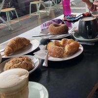 Bonsoy latte, chocolate chip cookie, croissant, glazed and cinnamon broduts, and a cappuccino. at Mister Nice Guy's Bakeshop in Ascot Vale