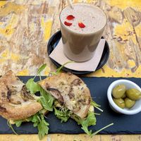 Focaccia with hummus, artichoke, rocket and carob protein shake   at MegaRawBar in Mallorca