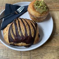 Pain au chocolat and pistachio muffin  at Crave Coffee & Bakery in Rotterdam
