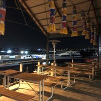 Tables overlooking water  at Annalakshmi in Perth