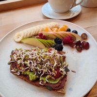 Vegan Brekkie (sourdough bread  tomato spread, avo spread, fresh tomatoes and sprouts + variety of fresh fruits) and oat Cappuccino at Lieblingsplatz in Bremerhaven